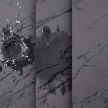 Black marble coffee mat absorbing water and hiding stains on textured surface.