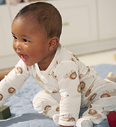 baby wearing a lion print bodysuit