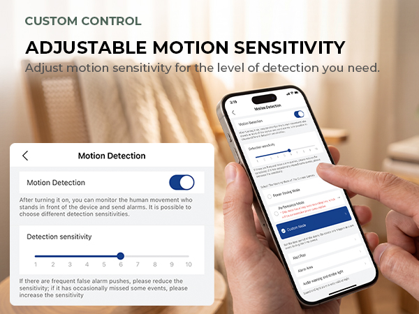 Person adjusts camera motion sensitivity in the mobile app on a smartphone.