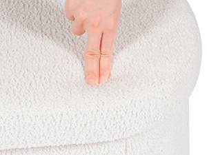 Close-up of finger pressing into a white textured surface, demonstrating material softness or texture.