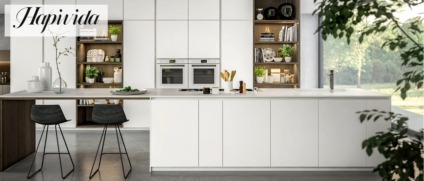 Modern minimalist kitchen interior with white cabinetry, clean lines, and large windows allowing natural light. Features sleek hardware and integrated appliances.