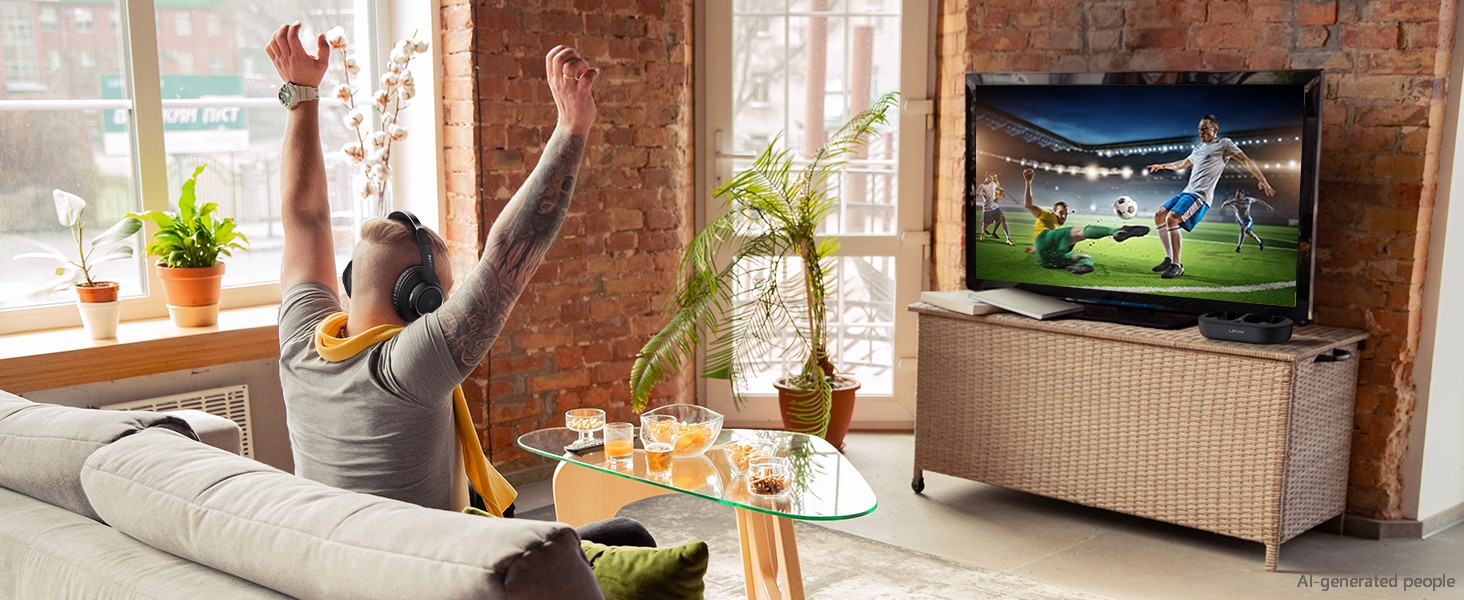 A man watches a wonderful football match with TV headphones
