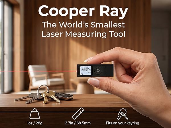 Text reads 'Cooper Ray', 'The World's Smallest', 'Laser Measuring Tool'. Hand holding compact digital laser measurement device with display screen over wooden surface with tools.