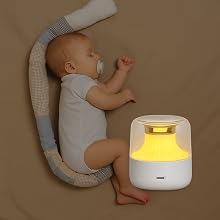TranquilTone sound machine glowing softly in a baby nursery, creating a soothing sleep environment.
