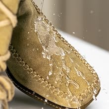Extreme close-up sequence showing crystalline or frosted texture on a golden-brown leather surface, possibly a shoe or accessory, with water droplets or ice crystals visible.