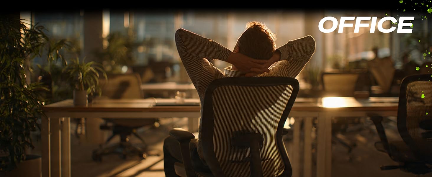 Man stretching at office desk after long workday with ergonomic mouse pad wrist rest support
