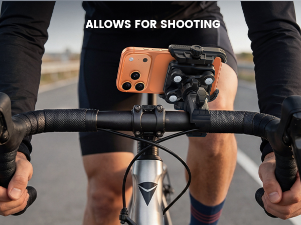 Text reads 'ALLOWS FOR SHOOTING'. Close-up of bicycle or camera mount attachment system showing black mounting hardware.