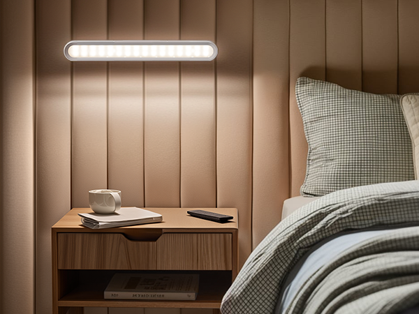 a small bedside table with a cup of coffee on it.