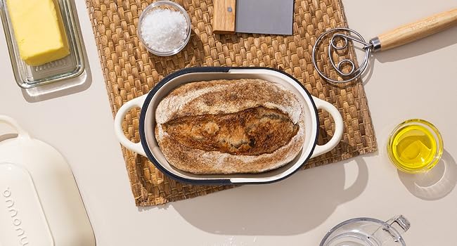 Assorted skincare products arranged on beige textured surface with cosmetic bottles, jars, and containers in neutral tones.