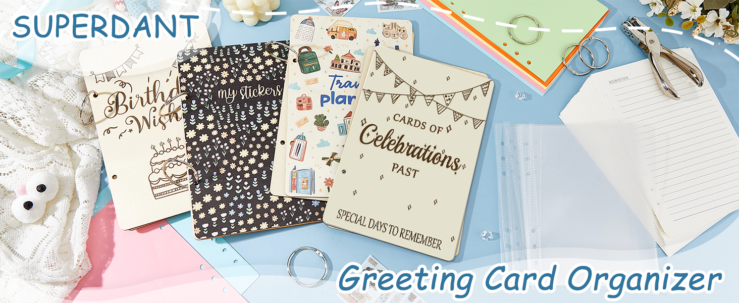 Greeting card organizer displaying various cards and envelopes on a colorful surface. Cards feature celebratory designs and text. A white organizer is visible on the right side of the image.
