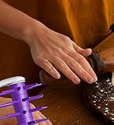 pizza dough roller pressing spikes into dough to prevent bubbles during baking