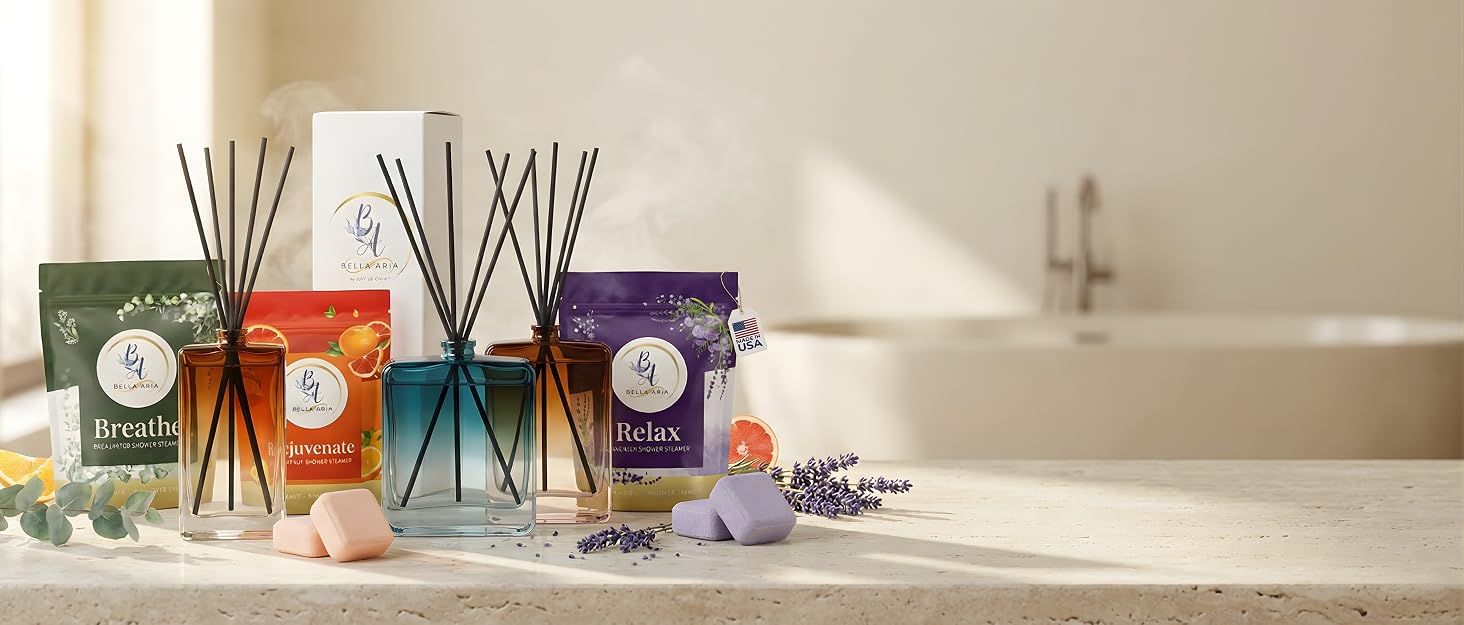 Luxury reed diffusers and shower steamers on a neutral surface with soft lighting a