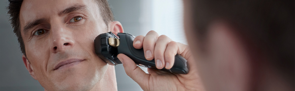 caucasian man shaving his cheek with Panasonic ES-LV67-K cordless electric shaver