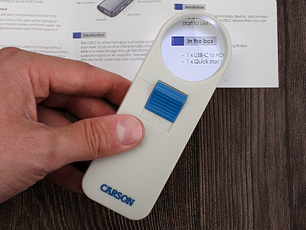 Photo of magnifier magnifying text on an instruction manual with LED light on