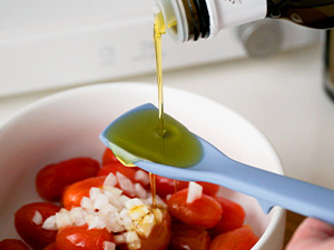 Mini silicone spoon used as a measuring spoon for oil and dressing