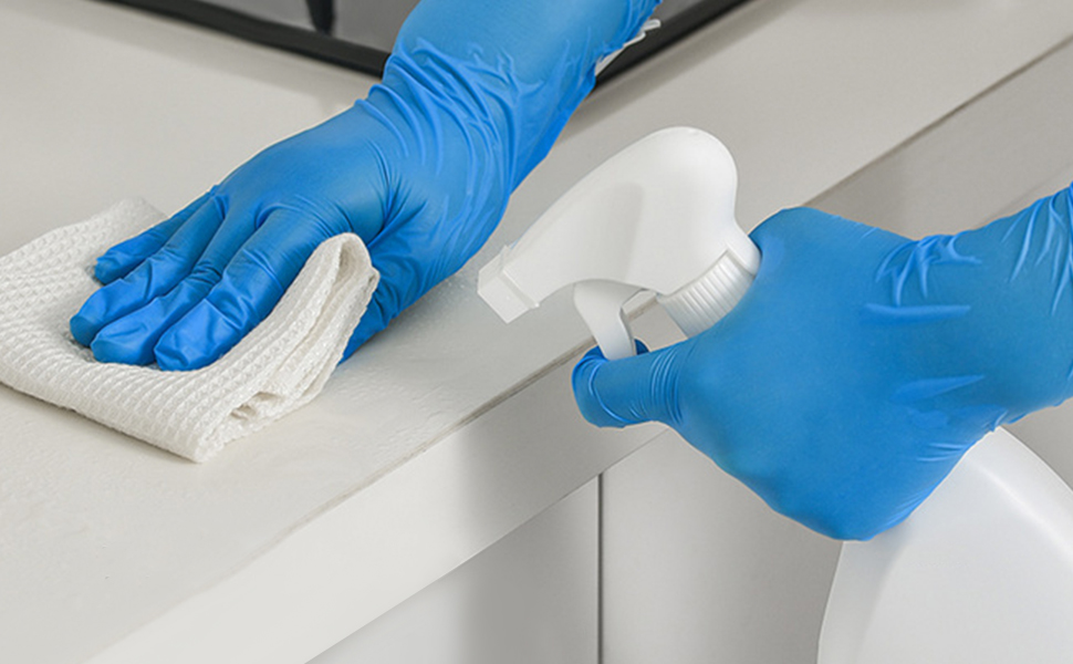 Purism 4 mil Nitrile household cleaning gloves wiping counter with spray.