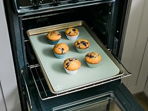 Blueberry muffins baked free-standing in silicone baking cups on a cookie sheet