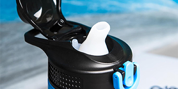 Closeup of open kids water bottle showing spout, spout cover, and button with lock