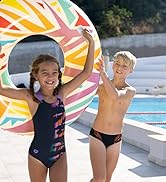 kids playing by the pool smiling wearing arena swimsuits on a pretty summer day