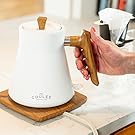 Woman's hand on wood ergonomic kettle handle