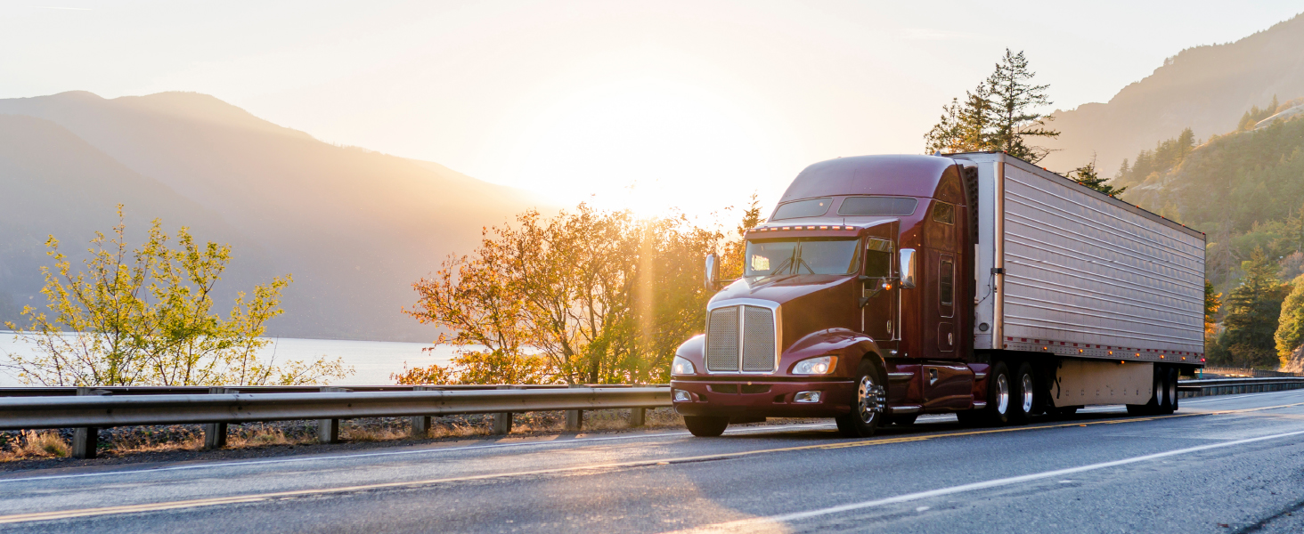 truck driving with trees in background