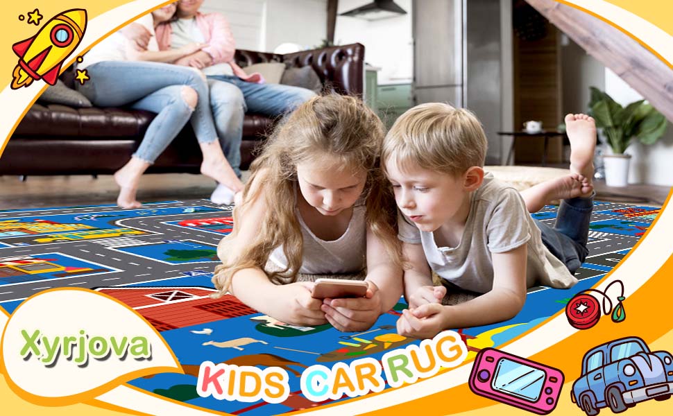 Two kids lying on the car track rug playing with mobile phones
