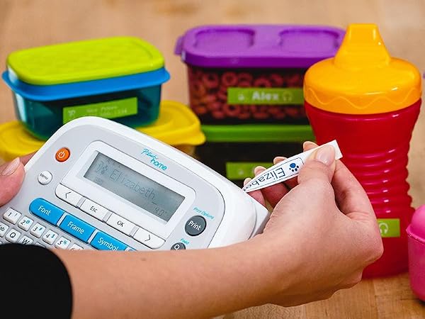 Various food storage containers and children's sippy cups with name labels
