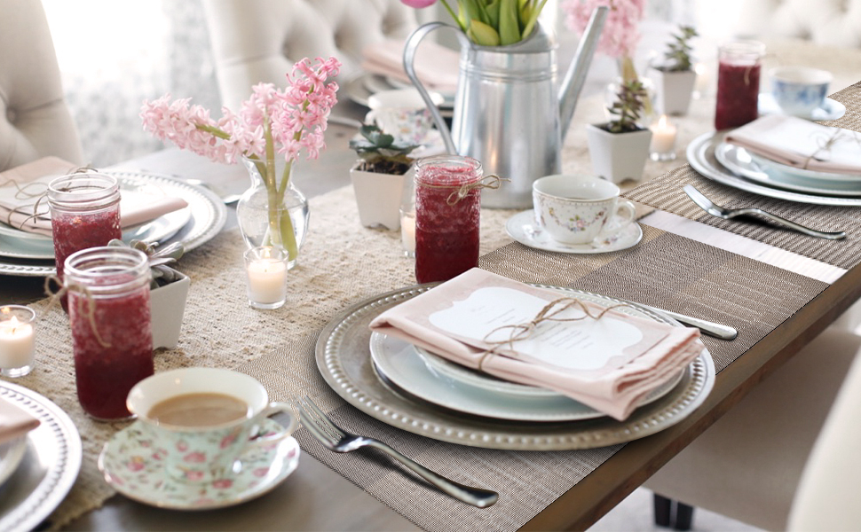 a spring table setting with pink flowers and a napkin