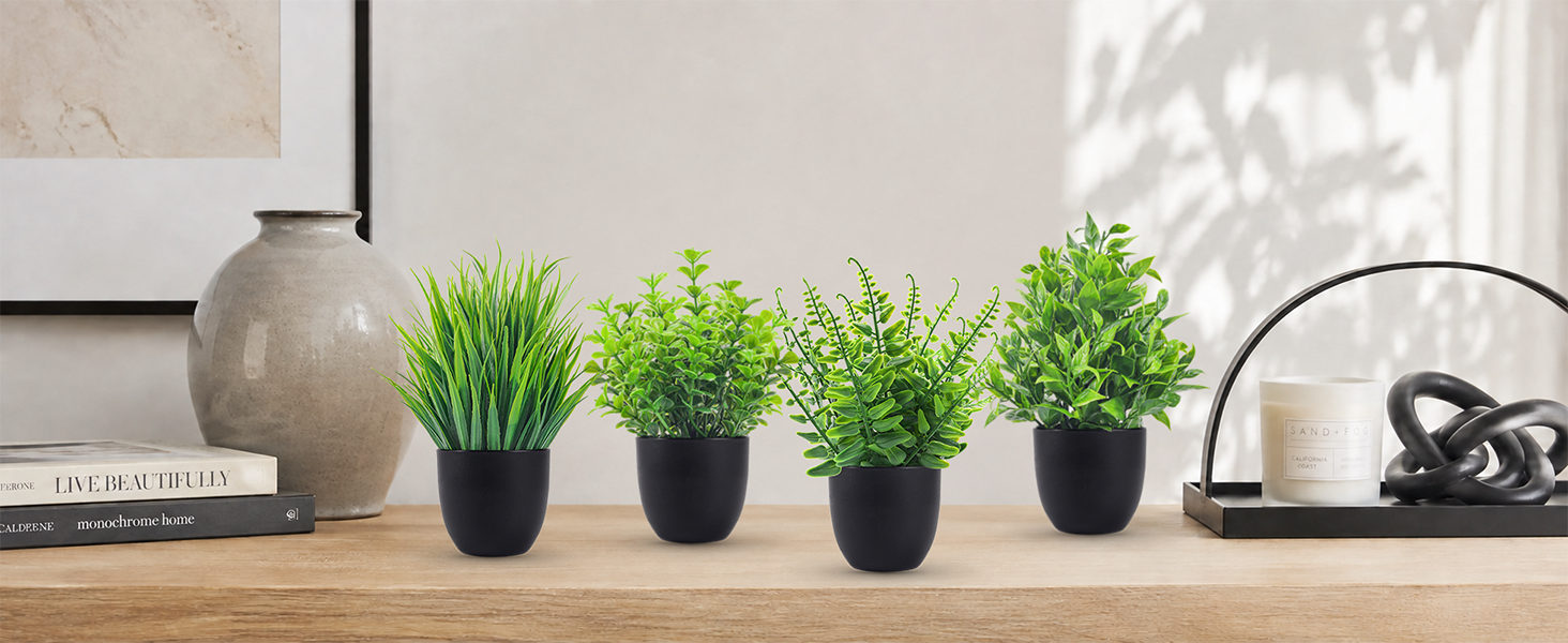 four artificial green plants black pots tabletop display