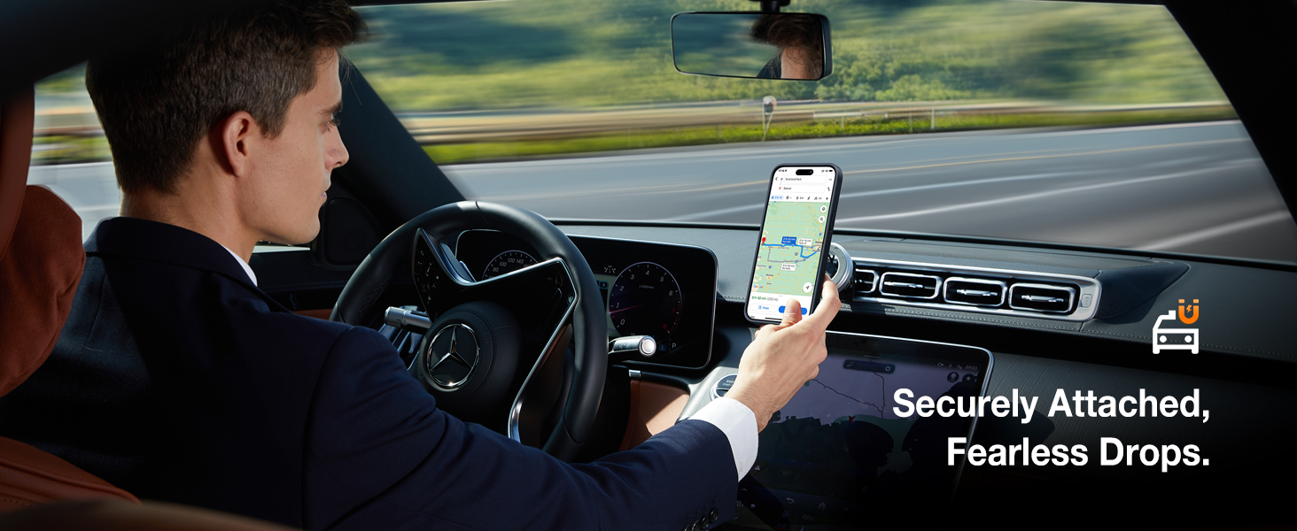 Smartphone mounted on car dashboard, displaying navigation app. Driver's hand touches screen while driving. Text: 'Securely Attached, Fearless Drops.'