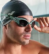 male wearing arena's The One Plus swim goggle in an indoor pool beautiful background in italy