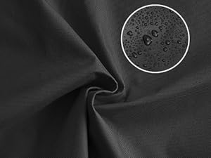 Close-up of dark fabric material with visible water droplets, suggesting water-resistant or waterproof properties.
