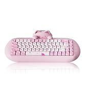 Pink mechanical keyboard with white keycaps in a cat-inspired design. Features curved ergonomic shape with raised ends resembling cat ears, and includes a white backlit display.