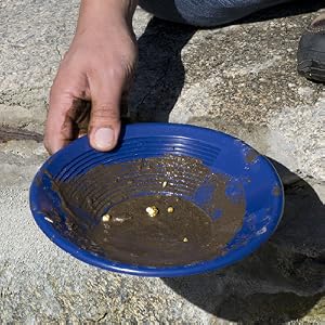 image of pan using gold pan to sift through dirt to find gold in water