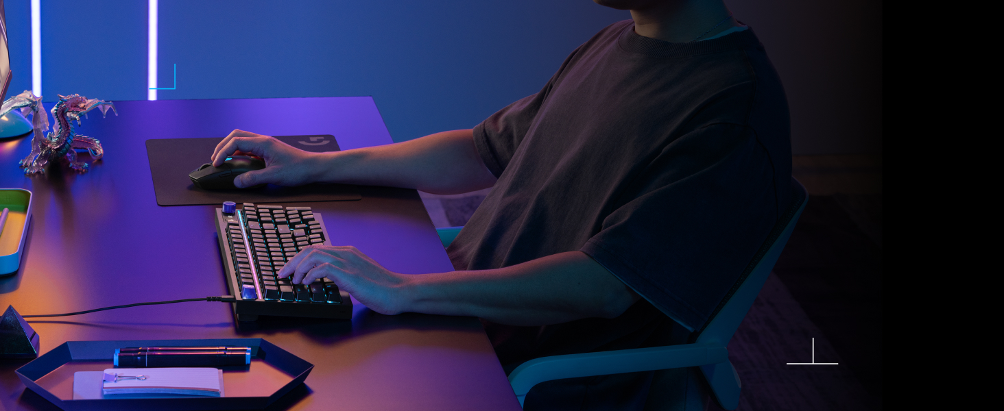 a person holding a mouse and typing on a keyboard