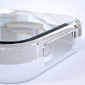 Close-up detail of clear protective eyewear showing transparent lens edge and black temple arm attachment.