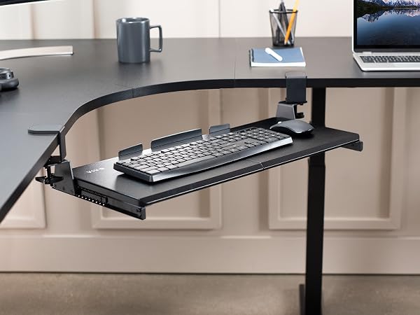 Keyboard tray secured to corner desk with swiveling desk clamps