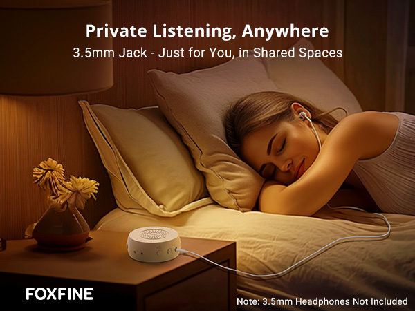 Woman resting in bed with headphones connected to FOXFINE sound machine