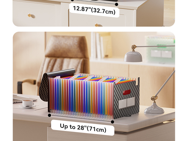 Expandable file organizer on desk, filled with colorful folders. Measures up to 28 inches (71cm) long and 12.87 inches (32.7cm) wide. Features mesh sides and red pull tab.