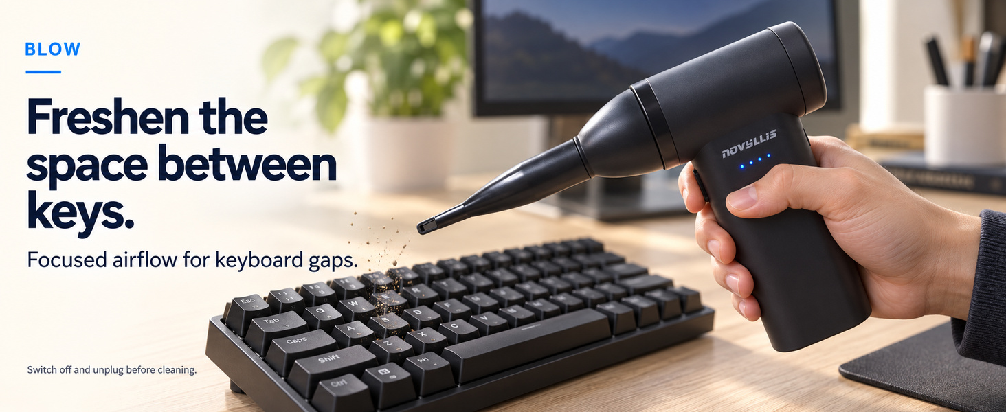 Electric keyboard air duster blowing loose dust from between keys with a narrow nozzle