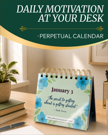Perpetual desk calendar with daily motivational quote on a work desk.