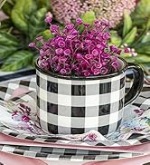 Black and white plaid mug sits on a matching paper plate and holds a purple faux plant