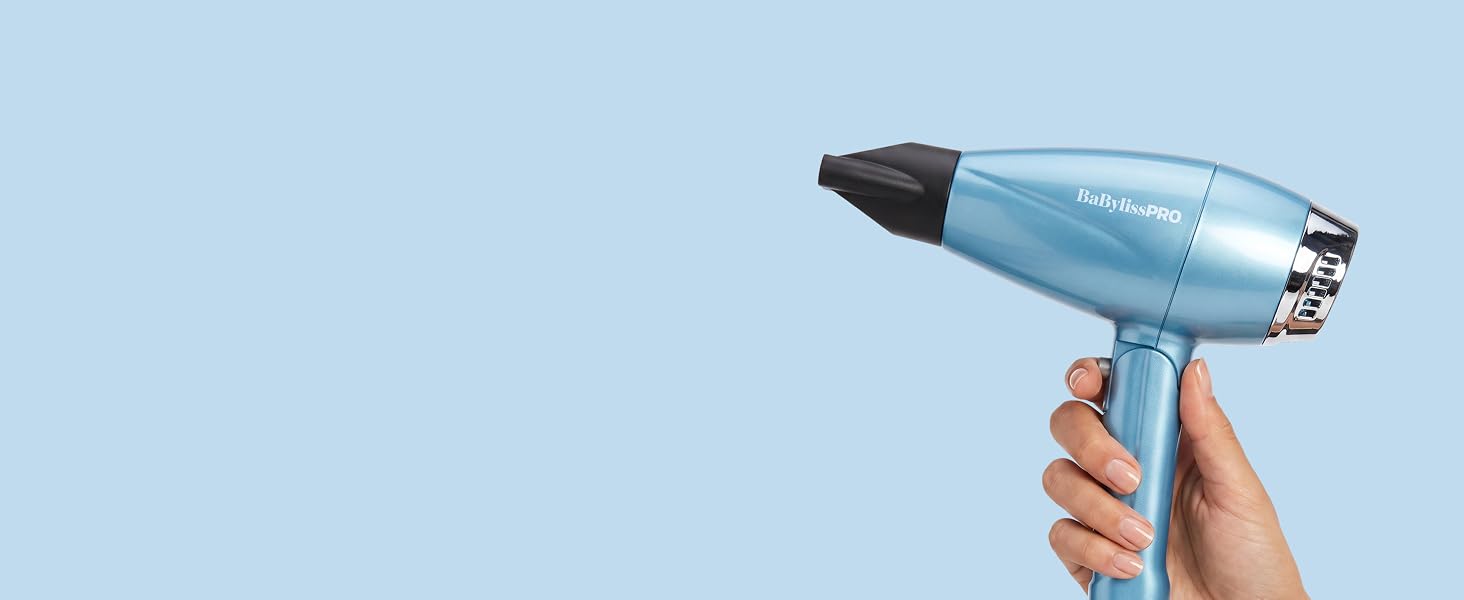 A hand holds the blue dryer with nozzle, highlighting folding, dual-voltage travel use.