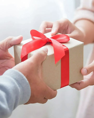a man giving a gift to a woman