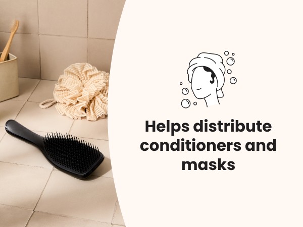 A black ultimate detangler brush laying on a bathroom counter.