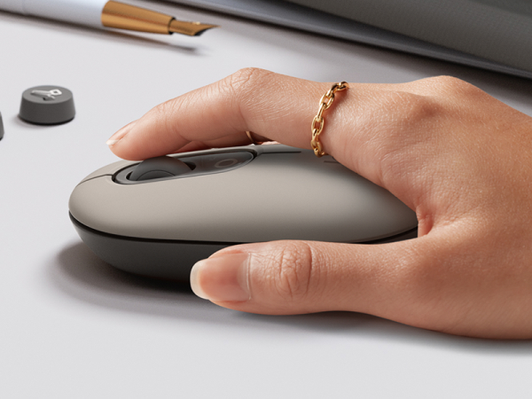a woman using pop mouse mist wireless beige gray mouse