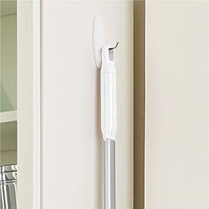Save even more space by using the handle loop to hang the sweeper up on the wall.