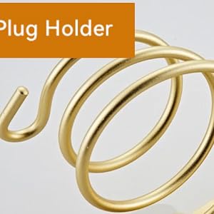 Spiral-shaped gold-colored metal plug holder with hook end, designed for wall mounting and cord organization.