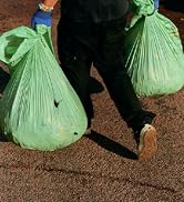 man carrying two large biobag liners