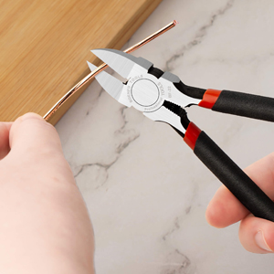 a pair of pliers cutting a piece of wood.
